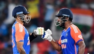 India's Sanju Samson (R) and captain Suryakumar Yadav bump their fists during the third and final Twenty20 international cricket match between India and Bangladesh at the Rajiv Gandhi International Stadium in Hyderabad on October 12, 2024. (Photo by Noah SEELAM / AFP)