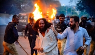 Police detain a Tehreek-e-Labbaik Pakistan (TLP) party member during a protest in Karachi on October 13, 2024. (Photo by Qaisar Khan / AFP)