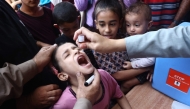 Palestinian children receive drops as part of a polio vaccination campaign in Deir al-Balah in the central Gaza Strip on October 14, 2024. Photo by Eyad BABA / AFP