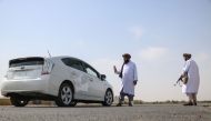 Taliban members of the Ministry for Propagation of Virtue and Prevention of Vice inspect vehicles at a checkpoint along a road on the outskirts of Herat province on October 4, 2024. (Photo by Mohsen Karimi / AFP)