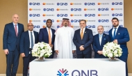 Senior Executive Vice President, QNB Group Retail Banking Adel Ali Al Malki; CEO of Noqoody Payment Services, Nayef Rashvan with other officials pose for a group photo.