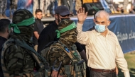 Archive photo used for demonstration purposes. Yahya Sinwar (R), leader of the Palestinian Hamas movement, greets supporters during a rally in Gaza City on May 24, 2021. Photo by MAHMUD HAMS / AFP.