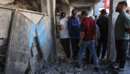 Displaced Palestinians check the damage inside UN school-turned-refuge in the Al-Shati refugee camp near Gaza City in the northern Gaza Strip, following a reported Israeli strike on October 19, 2024. Photo by Omar AL-QATTAA / AFP.
