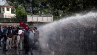 Police use water cannons to disperse supporters of Rabi Lamichhane, Nepal's former deputy premier, in Pokhara on October 20, 2024. (Photo by Yunish Gurung / AFP)