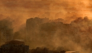 Smoke fumes cover a neighborhood of Beirut's southern suburbs near one of the runways of Beirut International Airport following an Israeli airstrike on on October 19, 2024. Photo by AFP.
