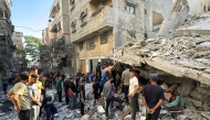 Palestinians inspect the damage after an Israeli airstrike in Beit Lahia, in the northern Gaza Strip on October 19, 2024. (Photo by Islam Ahmed / AFP)