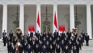 Indonesia's President Prabowo Subianto (front centre L) and Vice President Gibran Rakabuming Raka (front centre R) pose with newly sworn-in cabinet ministers in front of the Presidential Palace in Jakarta on October 21, 2024. (Photo by Bay Ismoyo / AFP)