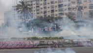 \Supporters of the Optimist Party for the Development of Mozambique (PODEMOS) run from tear gas lobbed at them by units of the Mozambican anti-riot police during a strike called in Maputo, on October 21, 2024. (Photo by ALFREDO ZUNIGA / AFP)
