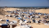 Tents sheltering people displaced by conflict are pictured with the Mediterranean sea in the background in the Mawasi area of Khan Yunis in the southern Gaza Strip on October 23, 2024. (Photo by Bashar Taleb / AFP)