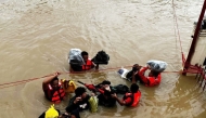 In this handout photo from the Philippine Coast Guard (PCG) taken and received on October 24, 2024, rescuers conduct a rescue operations in a flooded area in Nabua, Camarines Sur, due to Tropical Storm Trami. (Photo by Handout / Philippine Coast Guard (PCG) / AFP)