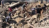 People inspect the scene of a site hit by an Israeli air strike on the village of El-Khodr in the centre of Lebanon's eastern Bekaa Valley on October 24, 2024. (Photo by Hassan SKEINE / AFP)
