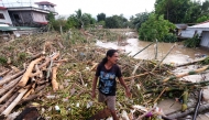  A man walks along the debris from the floods brought about by Tropical Storm Trami in Nabua, Camarines Sur on October 25, 2024. Photo by ZALRIAN SAYAT / AFP