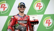 Ducati Lenovo Team's Italian rider Francesco Bagnaia celebrates coming in pole position in the qualifying session of the MotoGP Thailand Grand Prix at the Buriram International Circuit in Buriram on October 26, 2024. (Photo by Lillian SUWANRUMPHA / AFP)