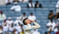 New Zealand's Mitchell Santner celebrates after taking the wicket of India's Ravichandran Ashwin during the third day of the second Test cricket match between India and New Zealand at the Maharashtra Cricket Association Stadium in Pune on October 26, 2024. (Photo by Punit PARANJPE / AFP)