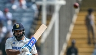 India's captain Rohit Sharma watches the ball after playing a shot during the third day of the second Test cricket match between India and New Zealand at the Maharashtra Cricket Association Stadium in Pune on October 26, 2024. (Photo by Punit PARANJPE / AFP)