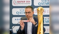 An official picks Denmark during the draw ceremony in Doha, yesterday.