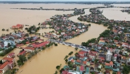 This aerial photo taken on October 29, 2024 shows cars parked on a bridge to avoid flood waters in Quang Binh province in central Vietnam. Photo by An Xa / AFP