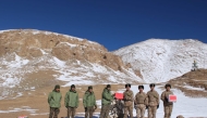 Indian and Chinese army greet each other along the Line of Actual Control (LAC) near Karakoram pass in Ladakh on October 31, 2024. (Photo by Indian Army / AFP) 