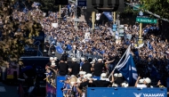 Los Angeles Dodgers’ players, staff, families and friends celebrate with fans during the Dodgers' World Series championship parade in downtown Los Angeles on November 1, 2024. (Photo by Etienne Laurent / AFP)