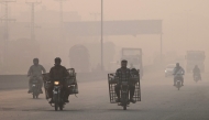 Commuters make their way amid smog in Lahore on November 2, 2024. (Photo by Arif Ali / AFP)