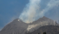 Smoke rises from Mount Lewotobi Laki-Laki as seen Klatanlo village, in East Flores Regency, East Nusa Tenggara, on November 4, 2024, after it erupted overnight. (Photo by Arnold Welianto / AFP)