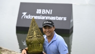 Richard T Lee poses with the winner's trophy. Photo by Asian Tour.