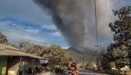 Villagers flee during an eruption of Mount Lewotobi Laki-Laki, a day after the previous eruption, in Boru Village, in East Flores, East Nusa Tenggara, on November 5, 2024. (Photo by Arnold Welianto / AFP)
 