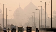 Commuters ride along a street engulfed in smog, in Lahore on November 5, 2024. Photo by Arif ALI / AFP