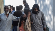 Families mourn the death of their relatives outside a hospital following a bomb blast at a railway station in Quetta on November 9, 2024. (Photo by Banaras Khan / AFP)