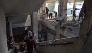 Palestinians check the damage inside a UN school-turned-shelter following an Israeli strike in the Al-Shati refugee camp on November 7, 2024. (Photo by Omar Al-Qattaa / AFP)