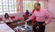 Former Prime Minister of Mauritius and candidate for Alliance du Changement, Navin Ramgoolam (R), casts his ballot during the 2024 Mauritian general election at a polling station in Port Louis on November 10, 2024. (Photo by Rishi ETWAROO / L'Express Maurice / AFP)
