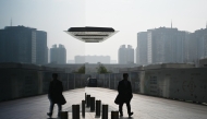 A man walks outside a building in the central business district in Beijing on November 10, 2024. (Photo by Greg Baker / AFP)