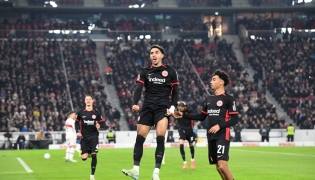 Frankfurt's Egyptian forward #07 Omar Marmoush (C) celebrates with Stuttgart's German defender #07 Maximilian Mittelstaedt (R) after scoring the 0-3 goal during the German first division Bundesliga football match VfB Stuttgart vs Eintracht Frankfurt in Stuttgart, southwestern Germany on November 10, 2024. (Photo by Thomas KIENZLE / AFP) 