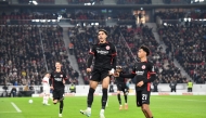 Frankfurt's Egyptian forward #07 Omar Marmoush (C) celebrates with Stuttgart's German defender #07 Maximilian Mittelstaedt (R) after scoring the 0-3 goal during the German first division Bundesliga football match VfB Stuttgart vs Eintracht Frankfurt in Stuttgart, southwestern Germany on November 10, 2024. (Photo by Thomas KIENZLE / AFP) 