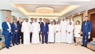 Minister of Investment, Industry and Trade H E Laziz Kudratov; QBA Chairman Sheikh Faisal bin Qassim Al Thani with QBA board members and other officials, yesterday. 