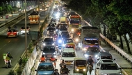 Commuters wait in a traffic jam during rush hour along a street in Bengaluru on November 12, 2024. (Photo by Idrees MOHAMMED / AFP)