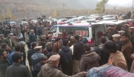 In this photograph taken and released by Pakistan's Gilgit-Baltistan Emergency Service (Rescue 1122) on November 13, 2024, mourners carry a deceased's body who died in a wedding bus accident in Gilgit. Photo by Gilgit Baltistan Emergency Service (Rescue 1122) / AFP