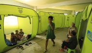 Residents from coastal areas take shelter on an evacuation center in Legaspi City, Albay province, south of Manila on November 16, 2024, ahead of Super Typhoon Man-yi's landfall. (Photo by Charism Sayat / AFP)