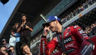 Ducati Italian rider Francesco Bagnaia smiles as he celebrates gettinhg the pole position after winning the Moto GP sprint race of the Solidarity Grand Prix of Barcelona at the Circuit de Catalunya on November 16, 2024 in Montmelo on the outskirts of Barcelona. Photo by Manaure Quintero / AFP.