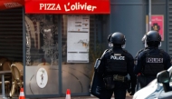 Police officers stand outside the restaurant 