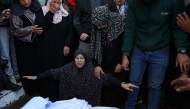 A Palestinian woman reacts in front of the bodies people killed in an Israeli strike, at the al-Aqsa Martyrs Hospital in Deir Al-Balah in the central Gaza Strip on November 17, 2024. (Photo by BASHAR TALEB / AFP)
