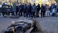 People look at the remains of a downed Russian hypersonic missile Zircon, after it struck a five-storey residential building in Kyiv during a 