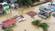 An aerial view shows submerged homes at a village in Ilagan, Isabela province on November 18, 2024, due to continuous heavy rains from Super Typhoon Man-yi. (Photo by Villamor Visaya / AFP