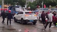 This frame grab taken from video footage circulating on Chinese social media on November 19, 2024, shows the scene where a car crashed outside the Yong'an primary school in Changde, central China's Hunan province. (Photo by social media / AFP) 