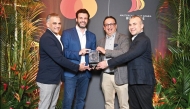 EGM and Head of Retail Banking of Commercial Bank, Shahnawaz Rashid; Head of Cards Issuance, Products and Portfolio of Commercial Bank, Srikumar Chandrot receiving the award during the Mastercard East Arabia Business Forum held in Singapore