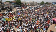 Supporters of the National Union for the Total Independence of Angola (UNITA) and other opposition groups hold banners and chant slogans as they march to protest against Angola's ruling party and President Joao Lourenco in Luanda, on November 23, 2024. Photo by Julio PACHECO NTELA / AFP.