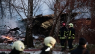 Lithuanian rescuers work next to the wreckage of a cargo plane following its crash near the Vilnius International Airport in Vilnius on November 25, 2024. A cargo plane flying from Germany to Lithuania crashed early on November 25, 2024 near the airport of the capital Vilnius killing one person, firefighters said. Photo by Petras MALUKAS / AFP.