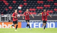 Al Rayyan’s Achraf Bencharki (left) celebrates with teammates after scoring the equaliser. 