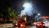 A rally truck used by Bushra Bibi, the wife of Pakistan's former prime minister Imran Khan, burns near the red zone after a protest to demand Khan's release, in Islamabad on November 27, 2024. (Photo by Aamir Qureshi / AFP)
 