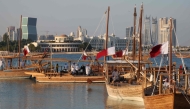 Traditional wooden boats sail during the 14th Traditional Dhow Festival at the Katara Cultural Village Foundation in Doha on November 27, 2024. (Photo by Karim Jaafar / AFP)